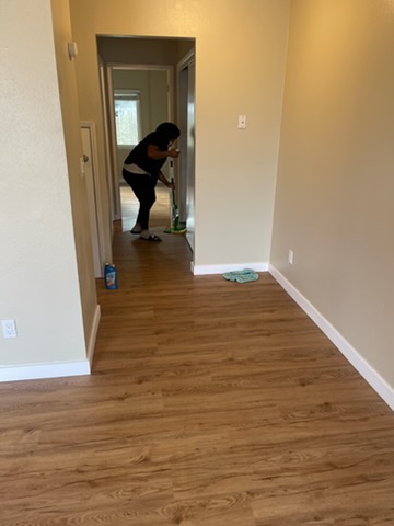 Mopping a hallway with a hardwood floor