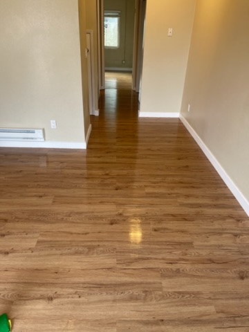 Freshly cleaned hardwood floor in an empty room